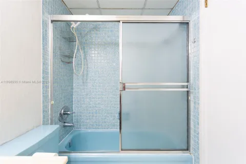 a bathroom with a glass shower door