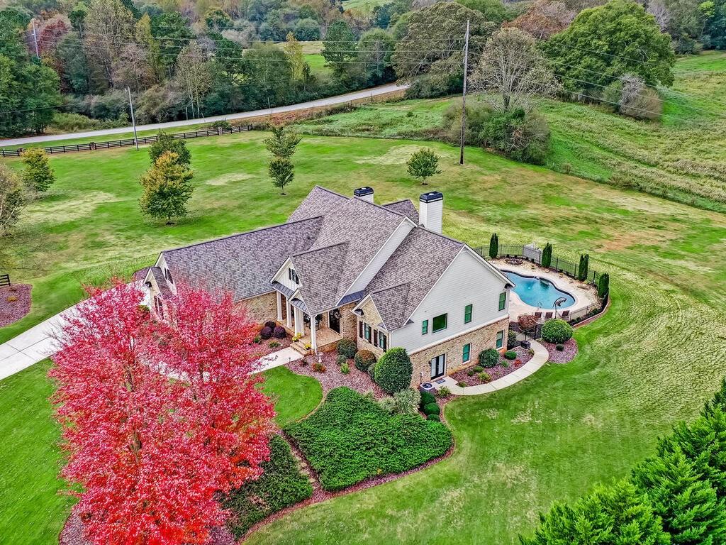 an aerial view of a house with a big yard