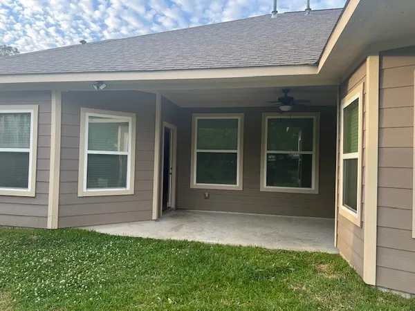 a view of a house with a backyard