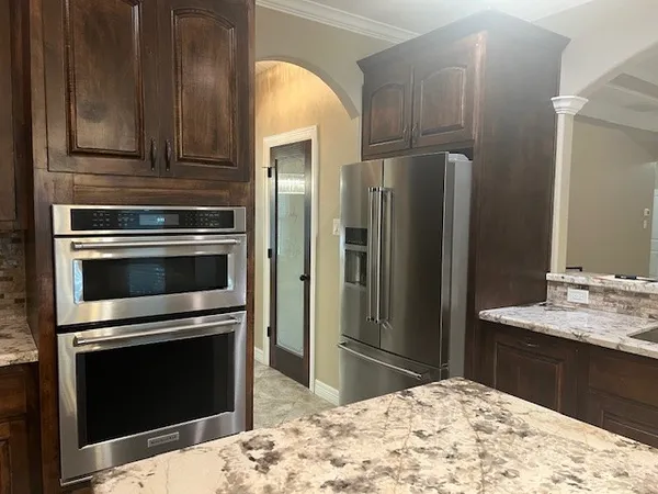 a kitchen with a sink and chandelier