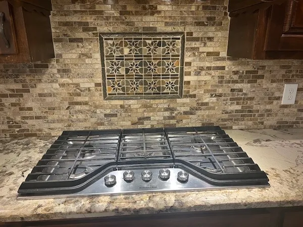 a kitchen with a table chairs and a chandelier