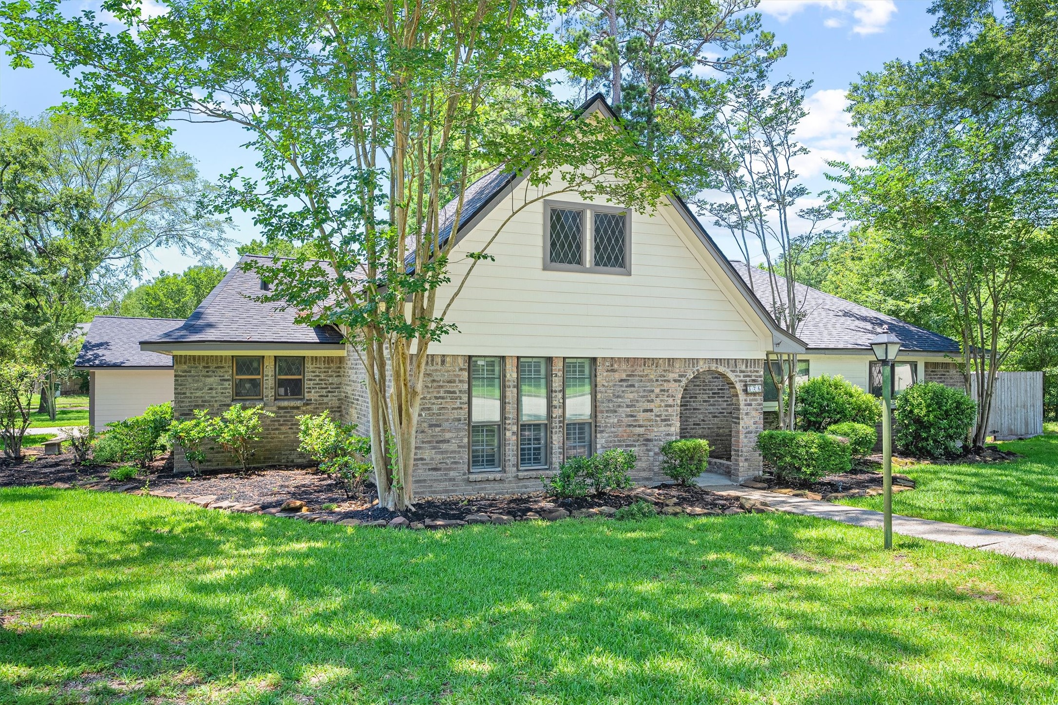 Welcome to 826 N Rivershire Drive, Conroe, Texas — this is what it looks like when a home sits on the right lot, in the right neighborhood, with the right bones. A one-story corner-lot charmer in the tree-lined community of Rivershire, Conroe — the brick and cement board exterior, fresh paint, and brand new roof make a strong first impression before you ever reach the front door.
