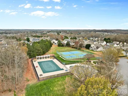 an aerial view of a house with a swimming pool outdoor seating and yard