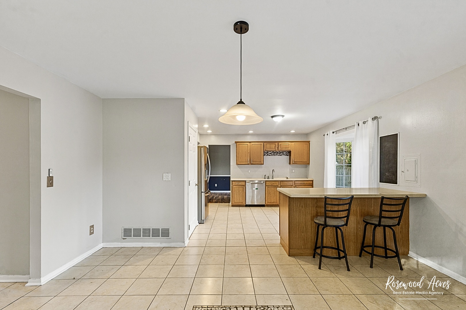 1403 West Budd Boulevard Kankakee, IL 60901 - Photo 11 of 46 a view of a dining room and livingroom with furniture wooden floor a chandelier