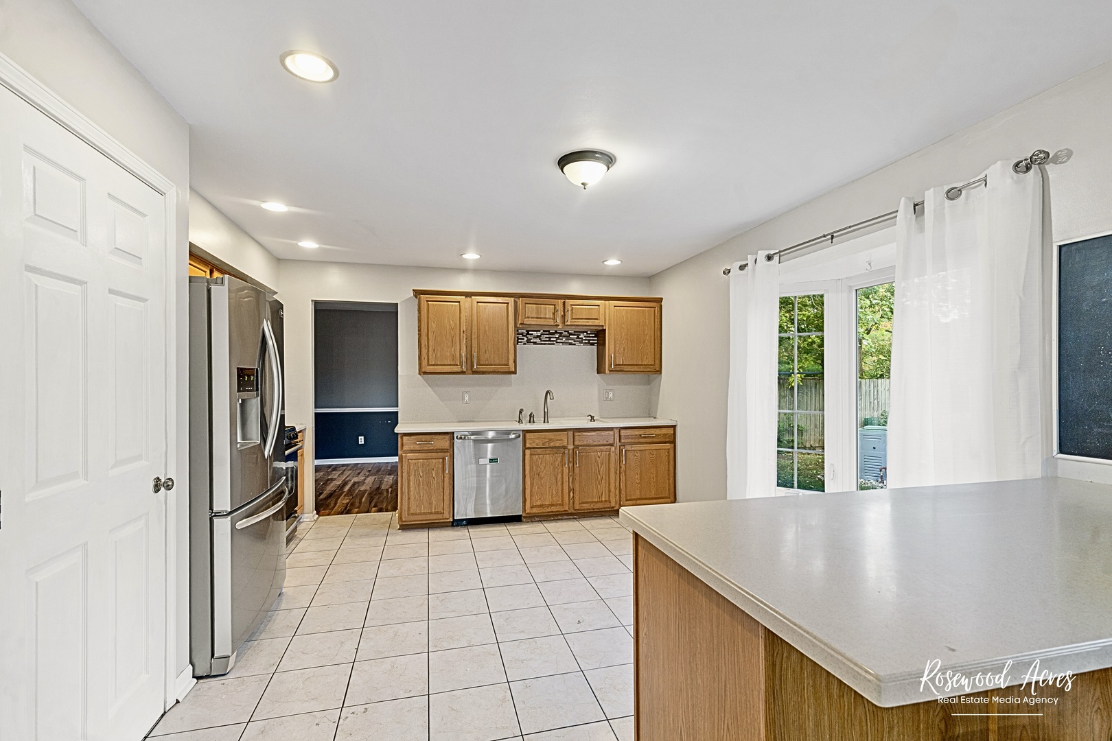 1403 West Budd Boulevard Kankakee, IL 60901 - Photo 13 of 46 a large kitchen with a large window and stainless steel appliances