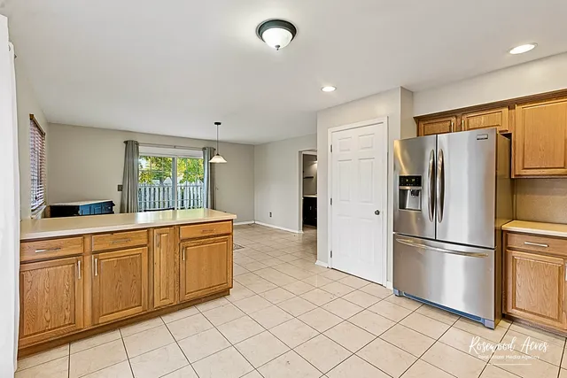 a kitchen with stainless steel appliances a refrigerator sink and cabinets