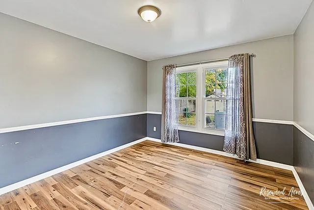 a view of a room with wooden floor and windows