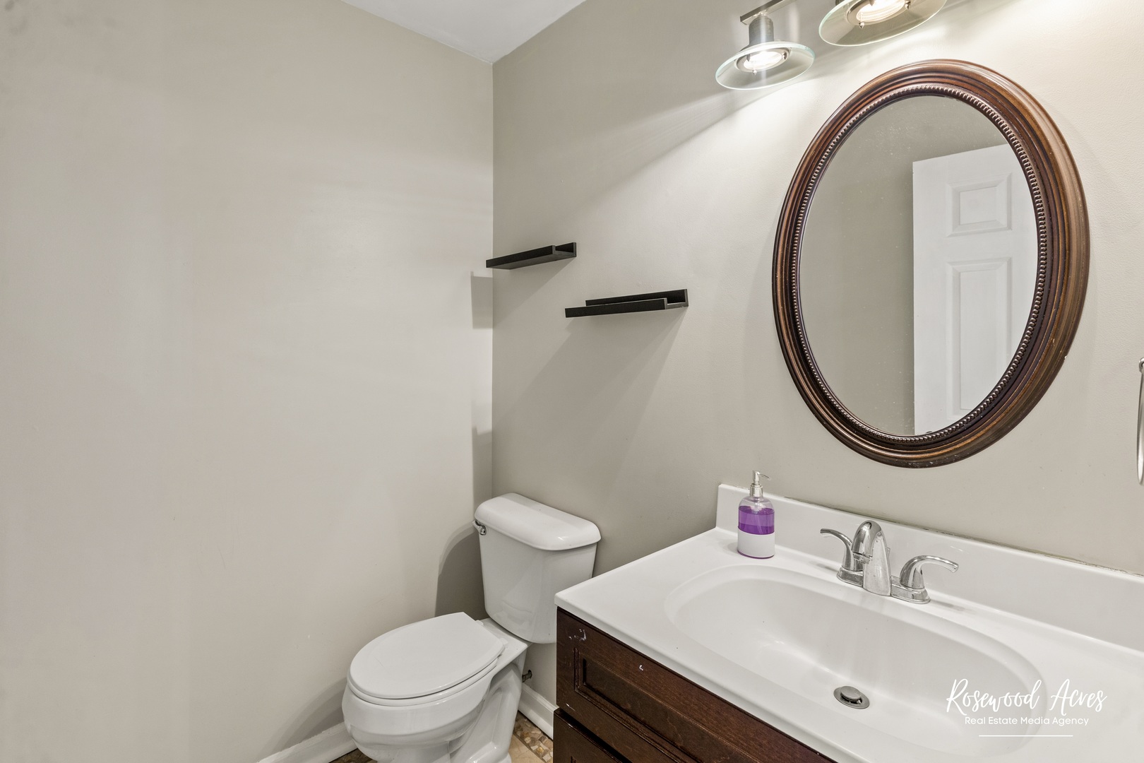 1403 West Budd Boulevard Kankakee, IL 60901 - Photo 22 of 46 a bathroom with a sink a toilet and a mirror