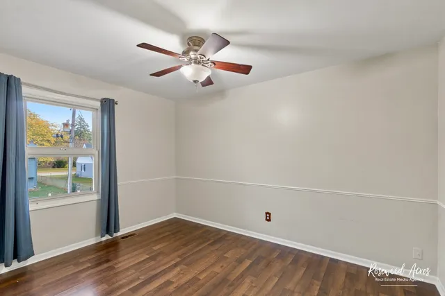 wooden floor in an empty room with a window