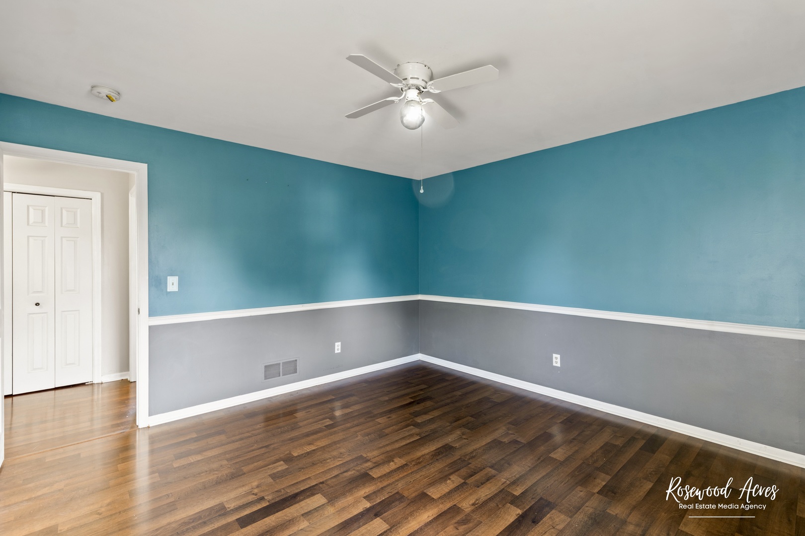 1403 West Budd Boulevard Kankakee, IL 60901 - Photo 29 of 46 an empty room with wooden floor and fan