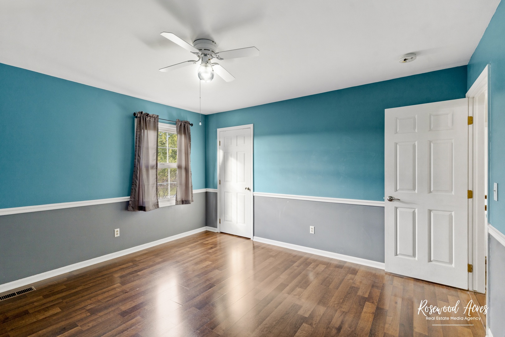 1403 West Budd Boulevard Kankakee, IL 60901 - Photo 31 of 46 an empty room with wooden floor fan and windows