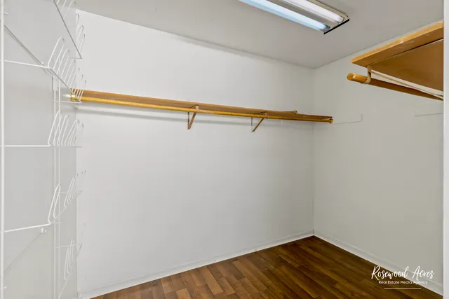 a bathroom with a granite countertop sink a mirror and a shower