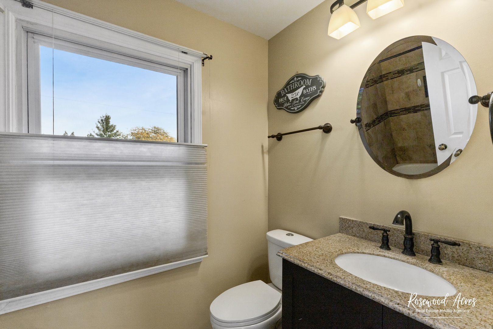 1403 West Budd Boulevard Kankakee, IL 60901 - Photo 38 of 46 a bathroom with a granite countertop toilet sink and mirror