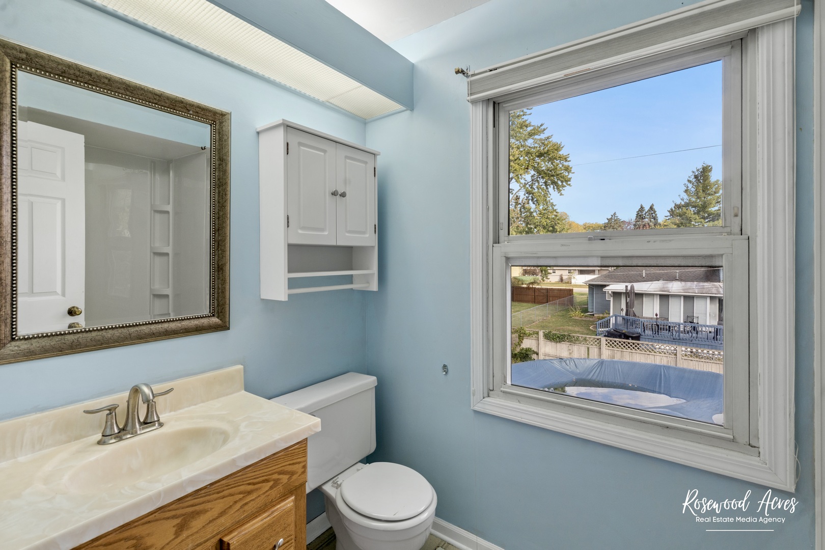 1403 West Budd Boulevard Kankakee, IL 60901 - Photo 40 of 46 a bathroom with a sink mirror and toilet