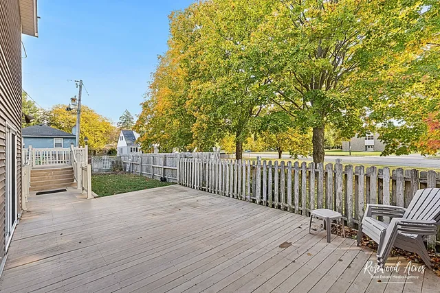 a white house that has a tree in front of it