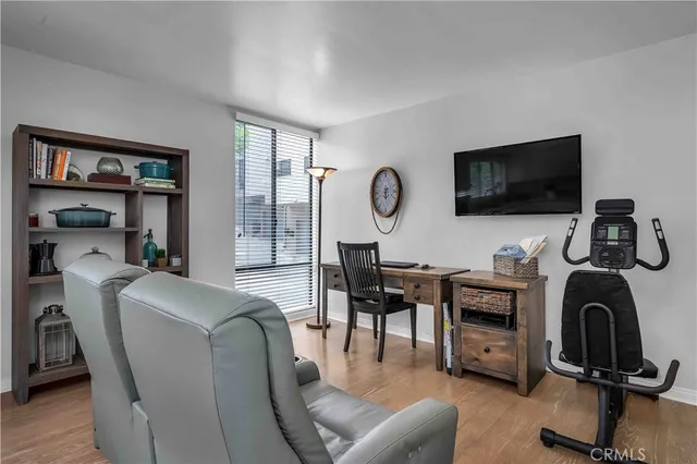a view of a livingroom with workspace and a couch