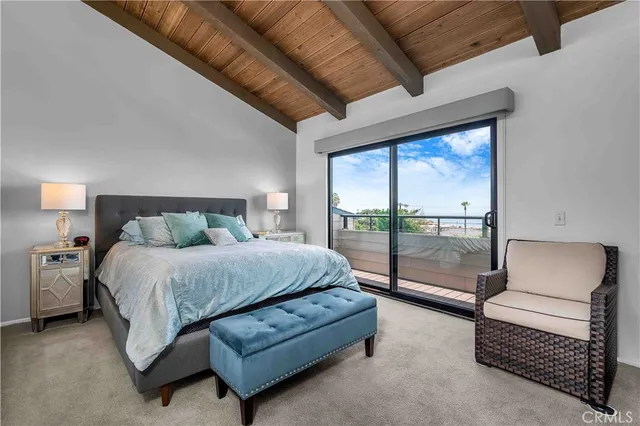 a bedroom with furniture and large windows