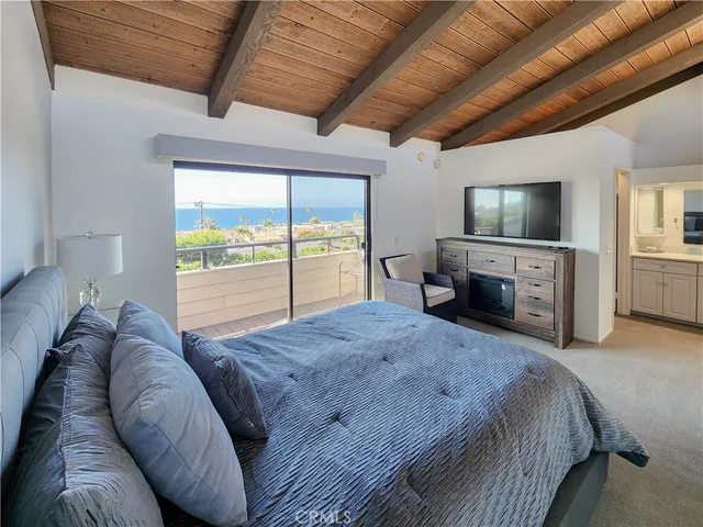 a bed room with a bed and a television