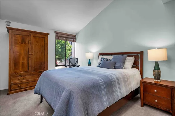 a bedroom with a bed and a night stand