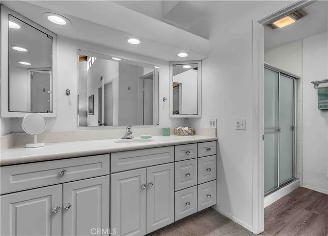 a bathroom with double sink and a mirror