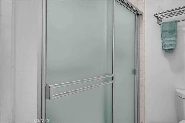 a bathroom with a glass shower door