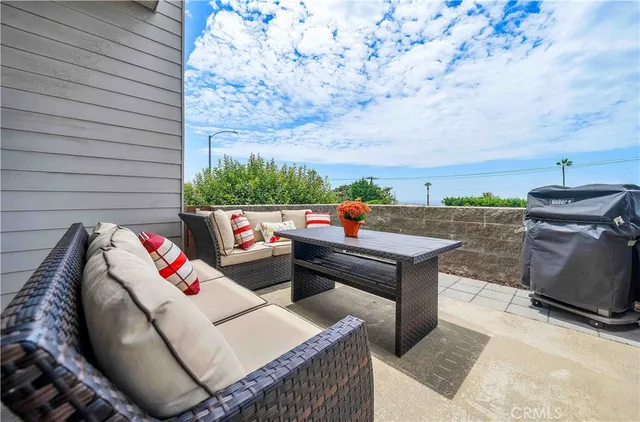an outdoor sitting area with furniture and city view