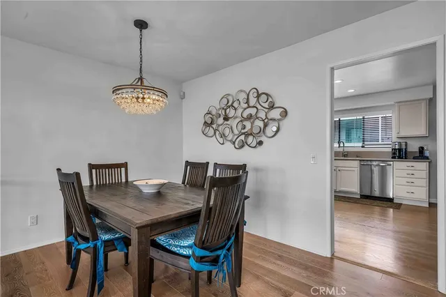 a view of a dining room with furniture wooden floor and a chandelier