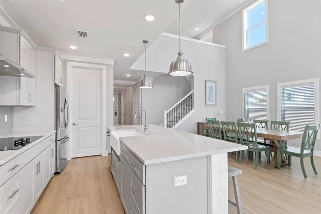 a kitchen with stainless steel appliances a stove a sink and a refrigerator