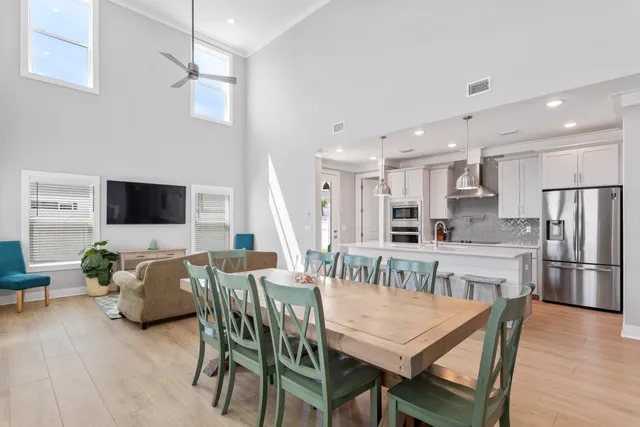 a view of a dining room with furniture and wooden floor