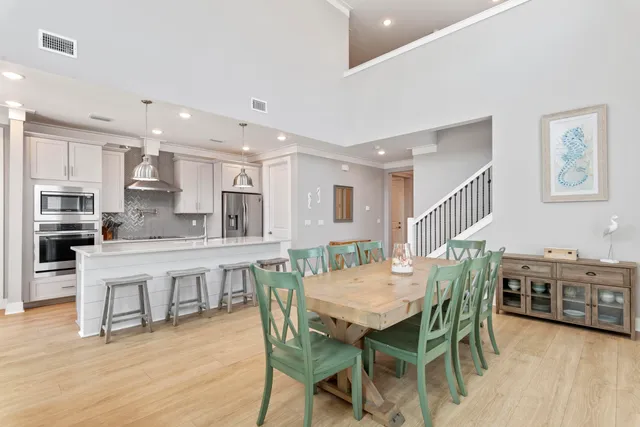 a living room with furniture wooden floor and a flat screen tv