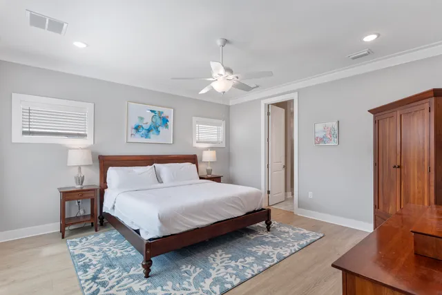 a bedroom with a bed and a flat tv screen on dresser