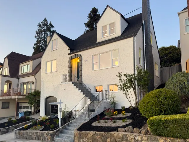 a front view of a residential apartment building with a yard
