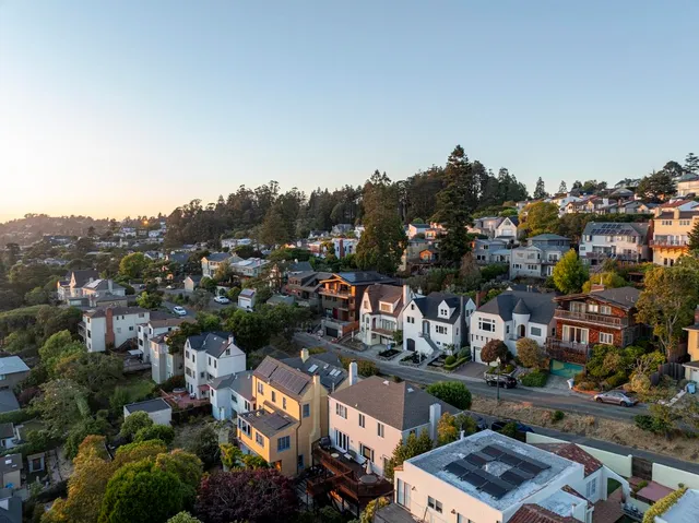 a front view of a residential apartment building with a yard