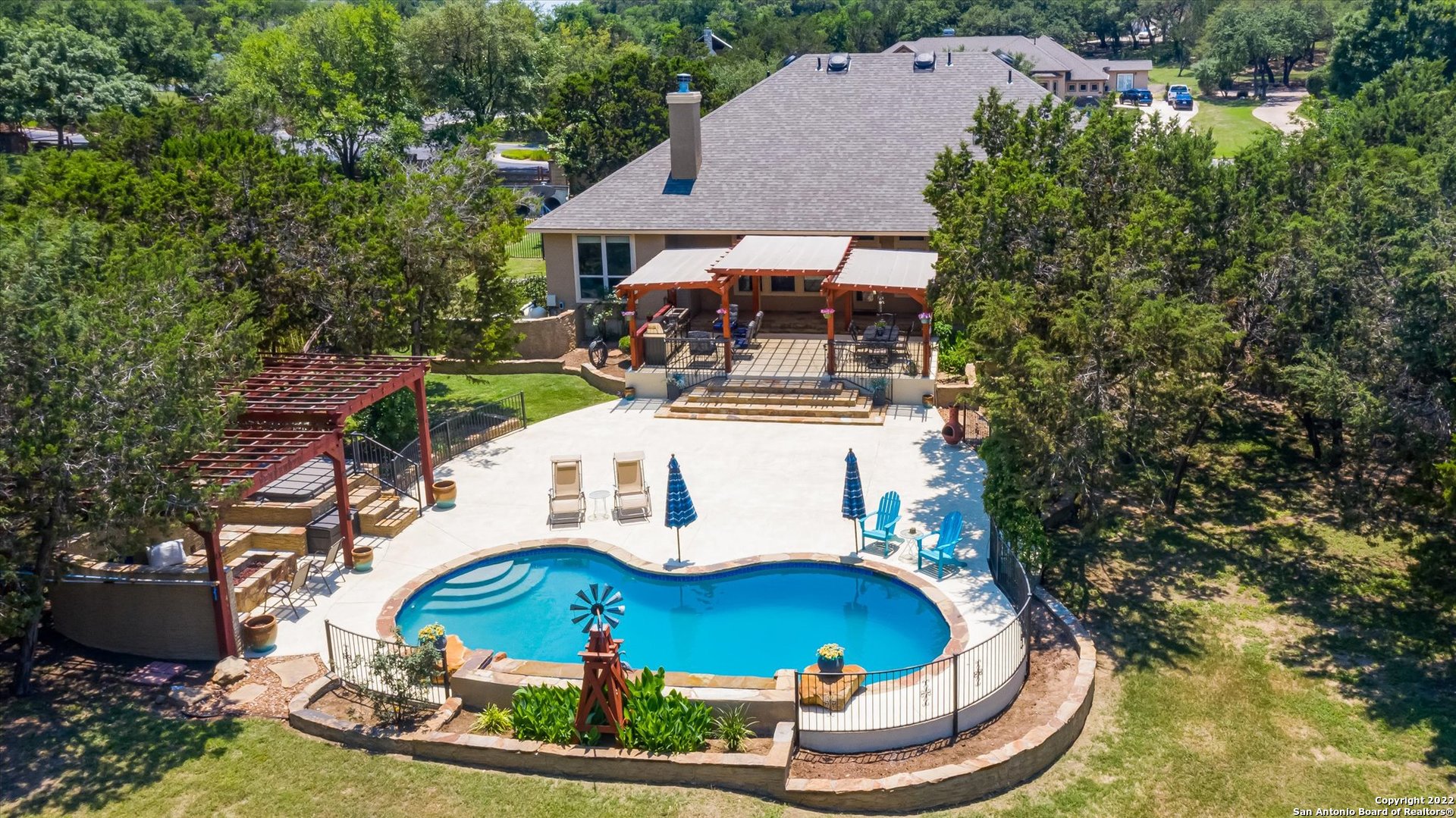 an aerial view of a house with outdoor space pool seating area and fire pit