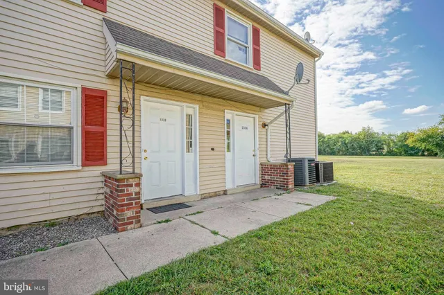 a view of a house with backyard and porch