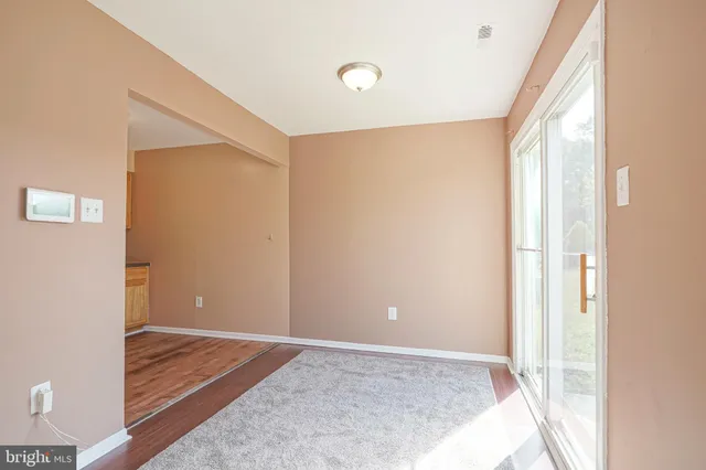 a view of room with window and wooden floor