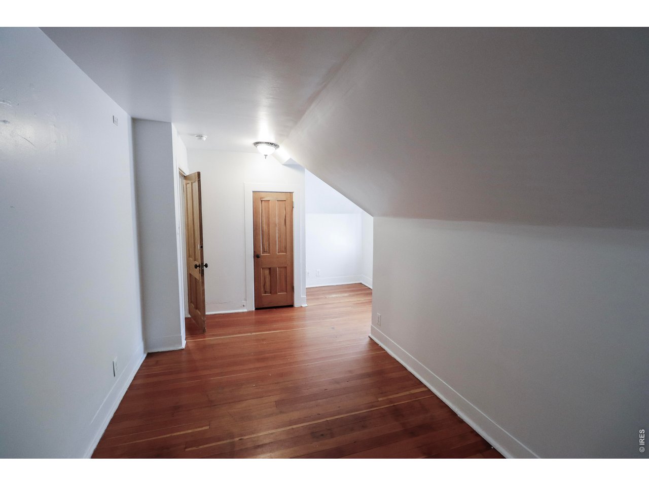 608 South Howes Street Fort Collins, CO 80521 - Photo 19 of 28 a view of a hallway with wooden floor