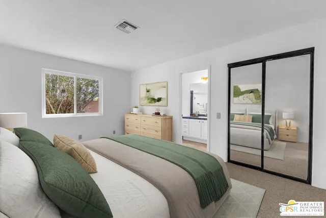 a bedroom with a bed and a refrigerator