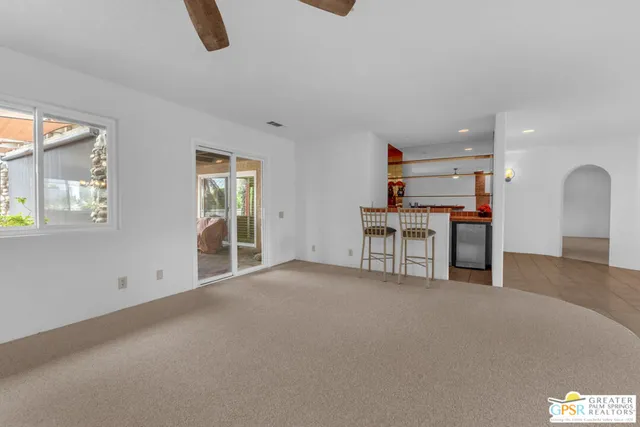 an empty room with furniture and windows