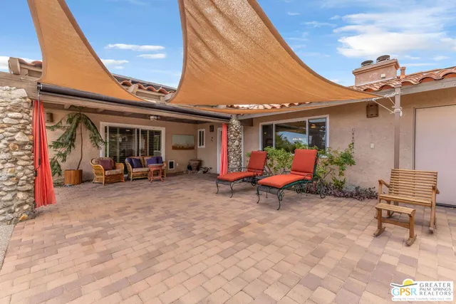 a view of a patio with table and chairs and potted plants