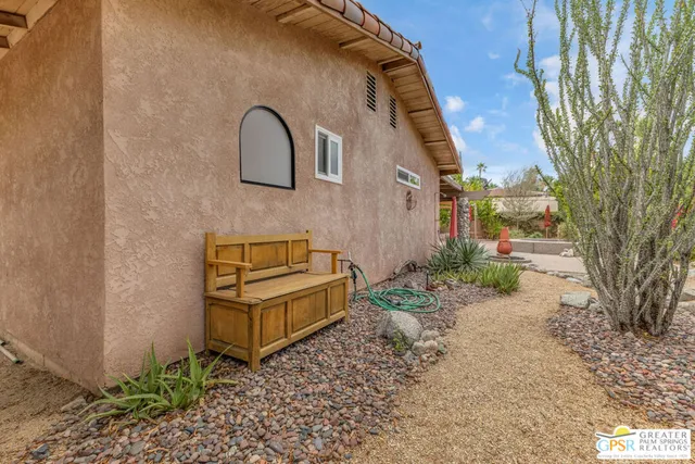 a wooden bench sitting in front of a building