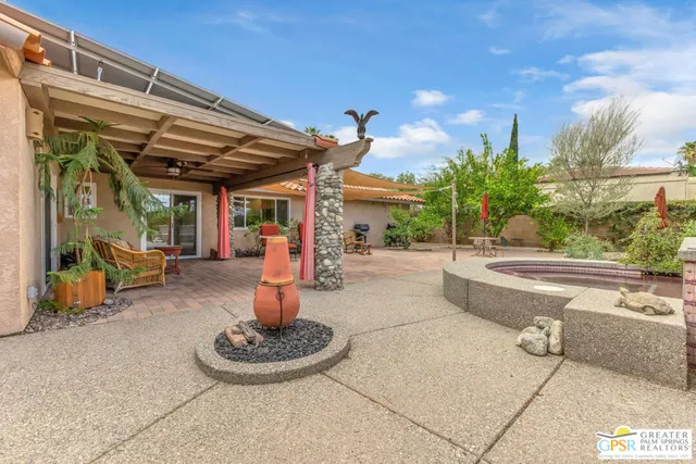 a swimming pool with potted plants and barbeque oven