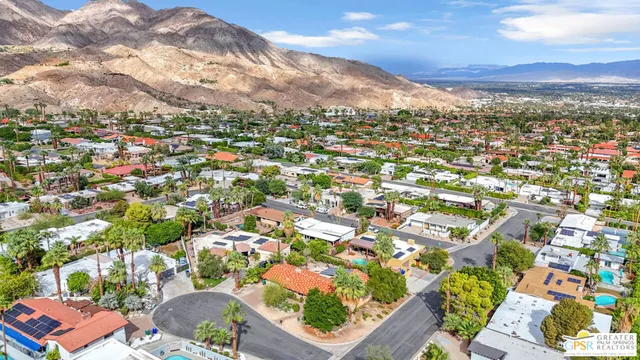 an aerial view of residential houses with outdoor space and street view
