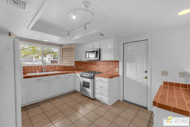 a kitchen with a cabinets and appliances