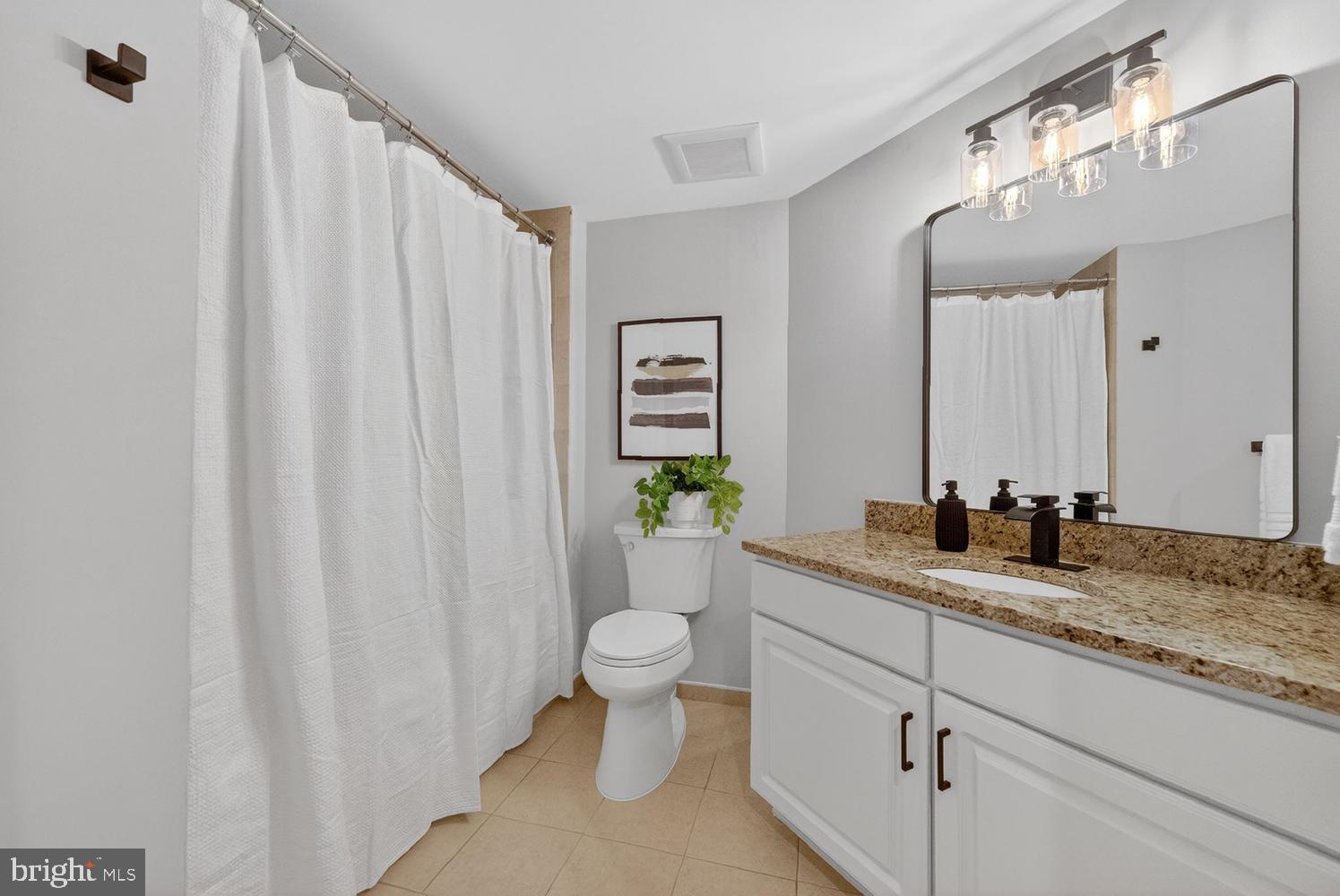 11800 Sunset Hills Road, Unit 314 Reston, VA 20190 - Photo 23 of 50 a bathroom with a granite countertop sink and a mirror