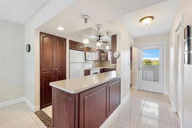a kitchen with kitchen island cabinets and refrigerator
