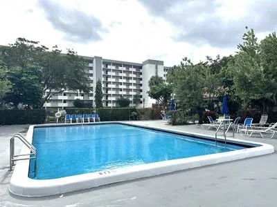 a view of swimming pool with outdoor seating and plants
