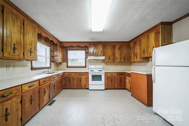 a kitchen with stainless steel appliances sink refrigerator and microwave