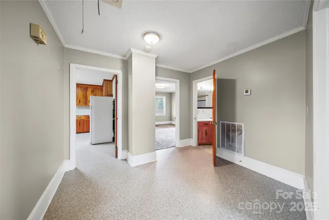 a view of a big room with closet and windows