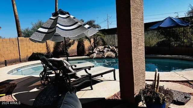 a view of a chairs and table in the patio with a yard